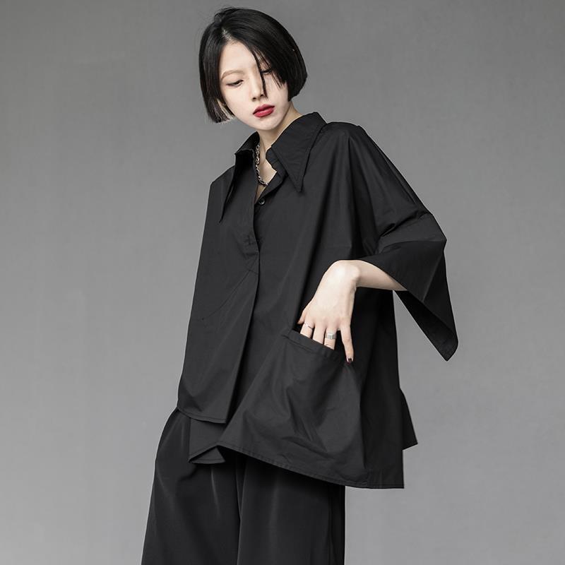 Black sculptural asymmetric polo in breathable technical silk